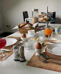 a table with eggs and plates of food on it at B&B Haus Kristal in Walsdorf +33 photos