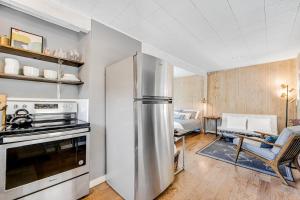 a kitchen with a stainless steel refrigerator and a living room at Melody Vineyard Cottage in Guerneville