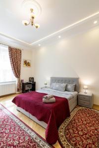 a bedroom with a large bed and a red rug at Apartment on Tamanskaya 3/4 in Lviv