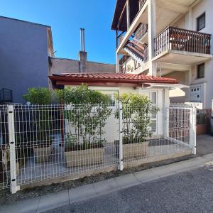 a white fence in front of a building at Cozy Studio Apartment Tian in Zagreb in Zagreb