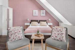 Schlafzimmer mit einem Bett mit 2 Stühlen und einem Tisch in der Unterkunft Vienna 15 Design Apartment in Wien