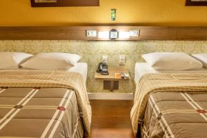 En eller flere senger på et rom på Hotel 10 São Leopoldo