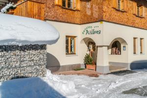 a building with snow in front of it at Hotel Pension Wilma in Schruns