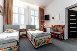 Posteľ alebo postele v izbe v ubytovaní Nasze Kamienice Apartament Express Rzeszów Główny