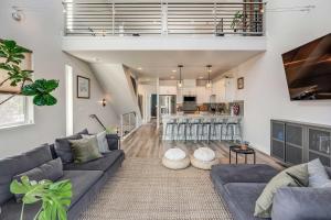 a living room with a blue couch and a kitchen at Reno Townhome with Mountain-View Rooftop Deck! in Reno