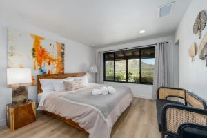 a bedroom with a large bed and a window at @ Marbella Lane - The Wine Mine Desert Escape in Joshua Tree