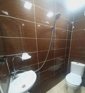 a bathroom with a toilet and a sink and a shower at Welcome Guests in Tbilisi City