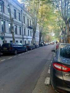 a street with cars parked on the side of the road at Welcome Guests in Tbilisi City