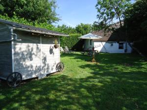 een schuur in een tuin naast een huis bij Holiday Home Lumassote in Trois-Ponts