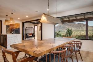 a kitchen and dining room with a wooden table and chairs at @ Marbella Lane - The Wine Mine Desert Escape in Joshua Tree