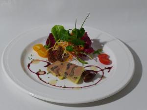a plate of food on a white plate at Hôtel-Restaurant de la Gare in Glovelier