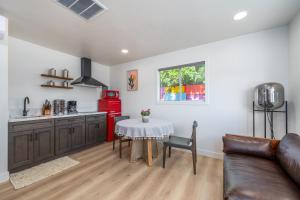 a kitchen and living room with a table and a couch at @ Marbella Lane - Rainbow House Glampers Paradise in Joshua Tree +8 photos