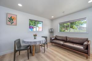 a living room with a couch and a table at @ Marbella Lane - Rainbow House Glampers Paradise in Joshua Tree