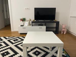 a living room with a tv and a table at NEVA APARTMENT in Belgrade