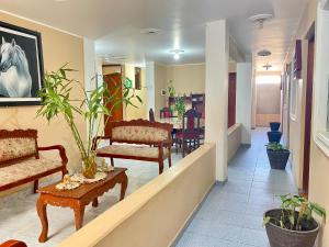 a hallway with chairs and tables in a building at Hospedaje Anais in Pisco