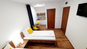 a small room with a bed and a table at Apartmani Brko in Kotor-Varoš