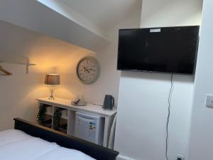 a bedroom with a flat screen tv on a wall at CityStays Rooms with Free Parking in Liverpool