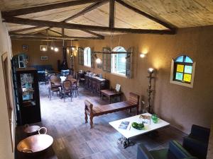 a living room with a table and a dining room at Pousada Sitio da Terra e Arte in São Roque