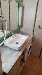 a bathroom with a sink and a mirror at Studio cosy, vue sur mer villages vacances Sainte anne chèques vacances acceptés in Sainte-Anne