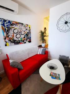 - un salon avec un canapé rouge et une table dans l'établissement Magnifique Duplex vue Mer, à Menton