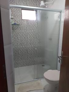 a bathroom with a glass shower with a toilet at CASA NO CONDOMÍNIO CAMINHO DA SERRA in Bananeiras