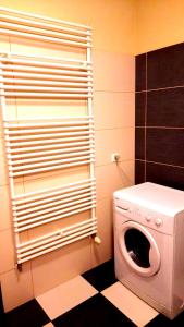 a washer and dryer in a bathroom with a window at Smart Rooms Poznan in Poznań
