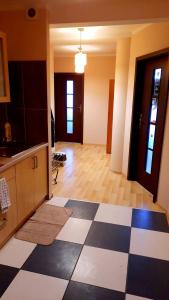 a kitchen with a black and white checkered floor at Smart Rooms Poznan in Poznań