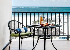 a table with chairs and a table cloth on it at Vela's Condos Ocean Front in Puerto Morelos