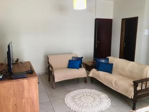 a living room with a couch and a chair and a tv at Apartamento Central -Centro Cunha in Cunha
