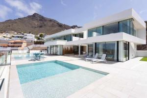 een huis met een zwembad ervoor bij New Home Costa Adeje Luxurious Private Villa in Adeje
