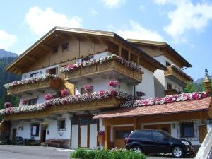 a building with flowers on the side of it at Chalet Belvedere in Arabba