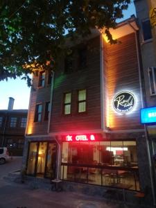 a building with a neon sign in front of it at Rumeli Konak Butik Otel in Tekirdağ