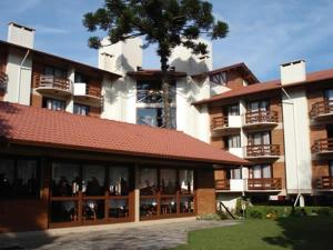 a large building with people sitting inside of it at Residencial Pousada do Serrano - 1 quarto in Gramado +4 photos