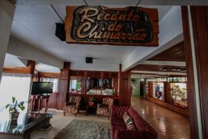 a lobby of a restaurant with a sign on the wall at Residencial Pousada do Serrano - 1 quarto in Gramado