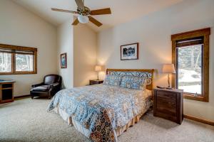 a bedroom with a bed and a ceiling fan at Bear Creek Retreat in Steamboat Springs