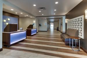a lobby of a hospital with a couch and tables at Holiday Inn Express Cheektowaga North East by IHG in Cheektowaga +40 photos