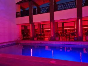 a swimming pool with red and blue lights at Hotel Batha in Fès