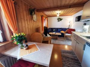 a kitchen and living room in a tiny house at Ferienwohnung Malerlehen in Schönau am Königssee
