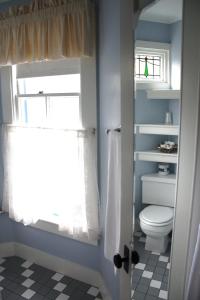 a bathroom with a toilet and a window at The Oak Bluffs Inn in Oak Bluffs