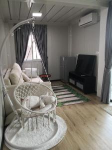 a room with a swing in a living room at Titiwangsa Cabin Retreats by Vale Pine in Kuala Lumpur