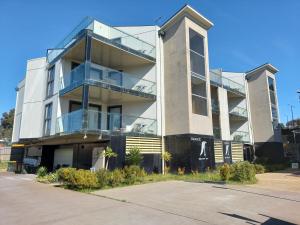 an apartment building with a glass facade at Apartments in Phillip Island Towers - Block C in Cowes