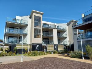 an apartment building with balconies and a parking lot at Apartments in Phillip Island Towers - Block C in Cowes