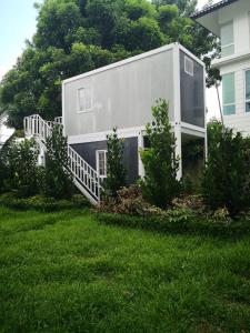 a house with a staircase in a yard at Titiwangsa Cabin Retreats by Vale Pine in Kuala Lumpur