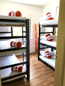 a room with two bunk beds and a table at Pinheiros Hostel & Food in Sao Paulo