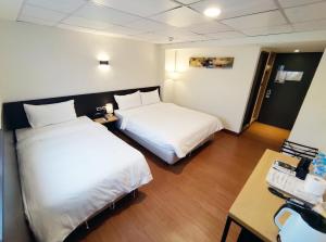 Voodi või voodid majutusasutuse 富裕商旅 RICH-hotel toas
