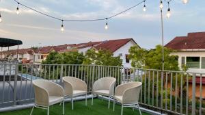 a group of chairs sitting on a balcony at Gallery@7Homestay in Shah Alam