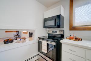 a kitchen with a stove and a microwave at Top floor 5th and Beall in Bozeman