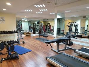 a gym with lots of exercise equipment and mirrors at EILAT GOLF RESIDENCE Apartment A 1 in Eilat