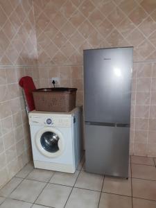 a kitchen with a washing machine and a washer at Sanlou in Port Shepstone