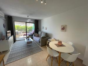 a living room with a table and a couch at Calpe Paraiso Playa primera linea in Calpe